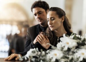 Grieving family at a funeral after a wrongful death in Houma, Louisiana.